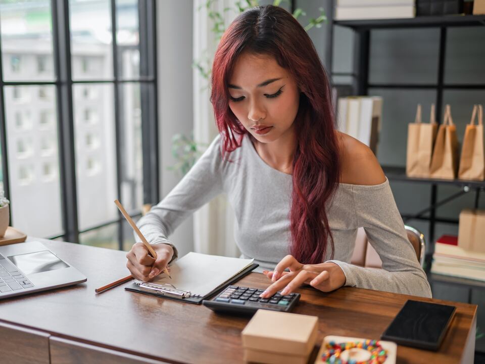 A bookkeeper reviewing accounts at her desk